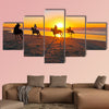 Horse riding on the beach at sunset multi panel canvas wall art