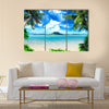 Tropical coast, beach with hang palm trees and sea, the island green and the sky Multi panel canvas wall art