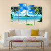 Tropical coast, beach with hang palm trees and sea, the island green and the sky Multi panel canvas wall art