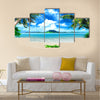 Tropical coast, beach with hang palm trees and sea, the island green and the sky Multi panel canvas wall art