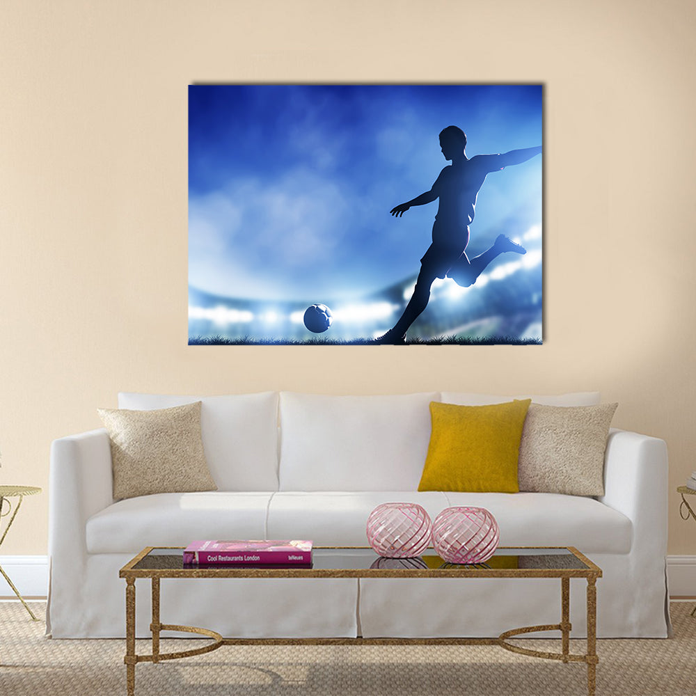 Football, soccer match A player shooting on goal Lights on the stadium at night Multi panel canvas wall art