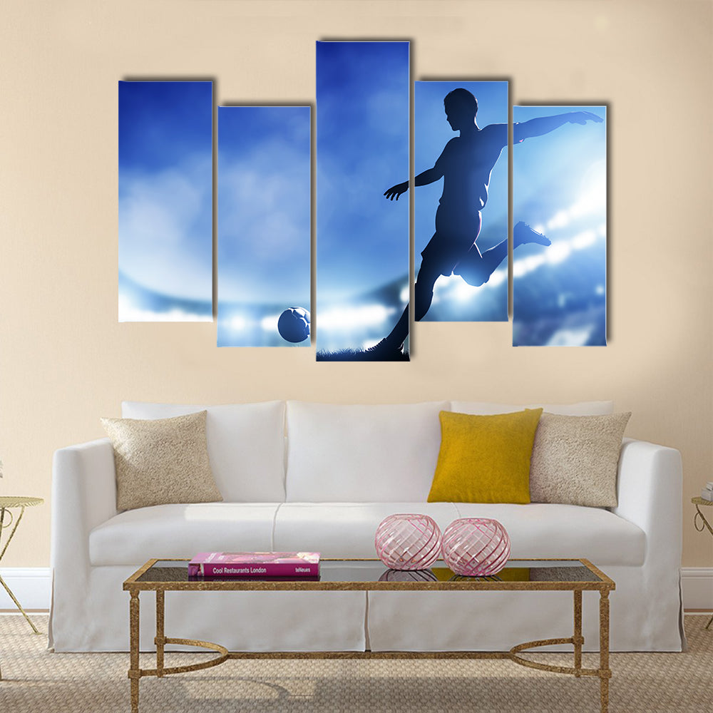 Football, soccer match A player shooting on goal Lights on the stadium at night Multi panel canvas wall art