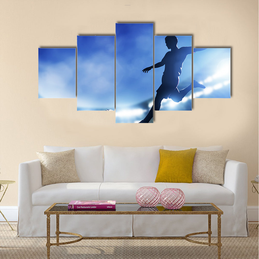 Football, soccer match A player shooting on goal Lights on the stadium at night Multi panel canvas wall art
