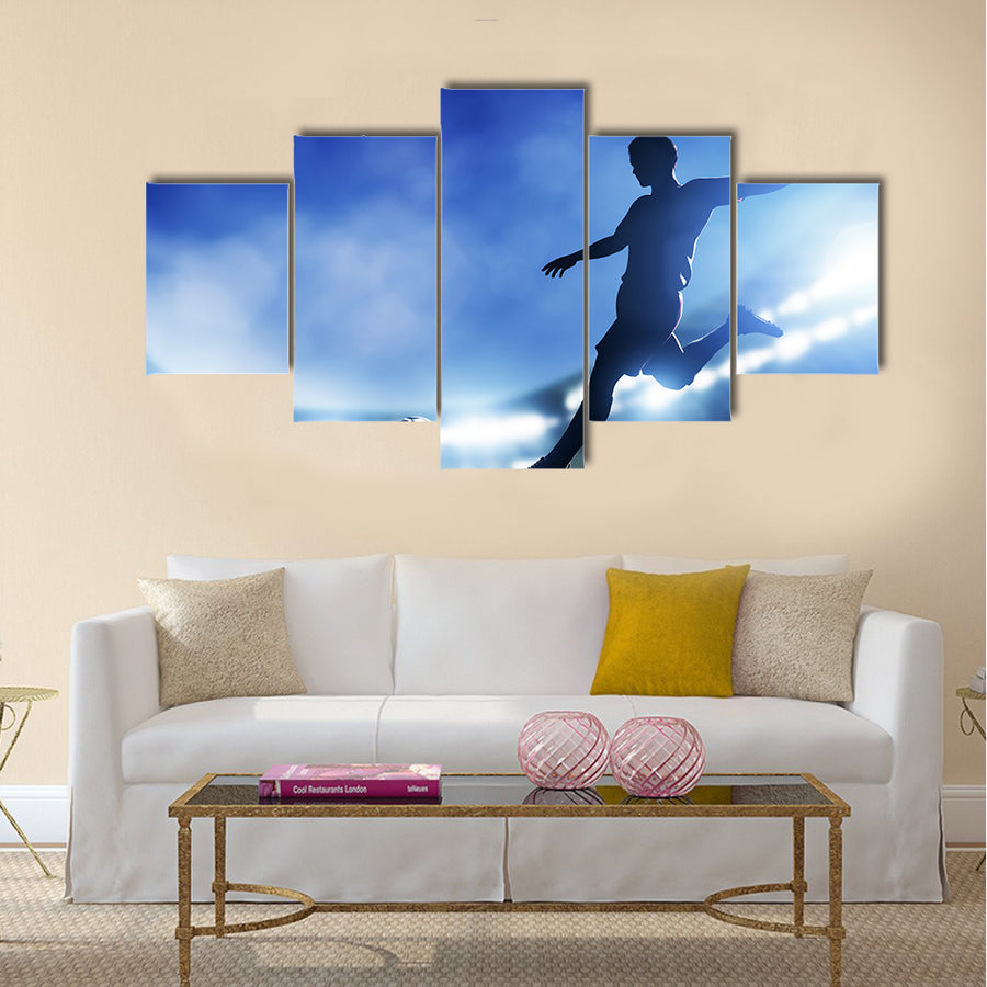 Football, soccer match A player shooting on goal Lights on the stadium at night Multi panel canvas wall art