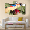 Cricket ball bat and gloves on the field Multi panel canvas Wall art