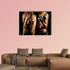 Bodybuilding Strong man and a woman posing on a black background Multi panel canvas wall art