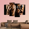 Bodybuilding Strong man and a woman posing on a black background Multi panel canvas wall art