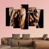 Bodybuilding Strong man and a woman posing on a black background Multi panel canvas wall art