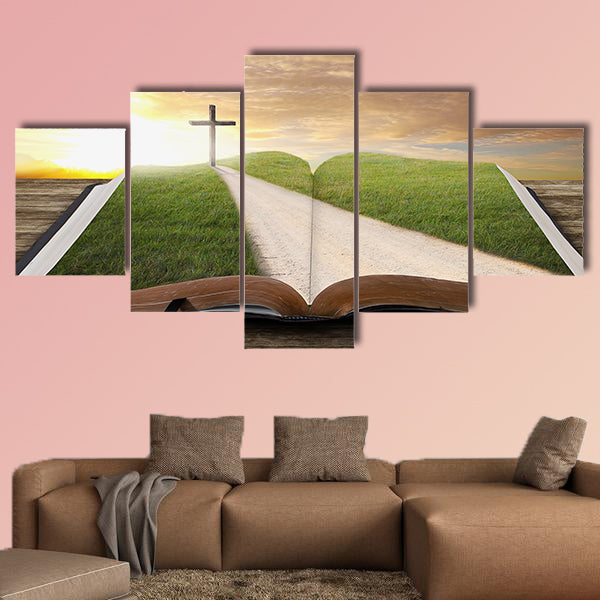 An open Bible with a road and grassy field leading to a cross multi panel canvas wall art