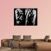 Bodybuilding strong man and a woman posing on a black background Multi panel canvas wall art