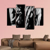 Bodybuilding strong man and a woman posing on a black background Multi panel canvas wall art