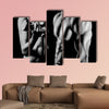 Bodybuilding strong man and a woman posing on a black background Multi panel canvas wall art