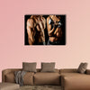 Bodybuilding Strong man and a woman posing on a black background Multi panel canvas wall art