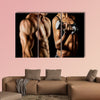 Bodybuilding Strong man and a woman posing on a black background Multi panel canvas wall art