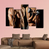 Bodybuilding Strong man and a woman posing on a black background Multi panel canvas wall art