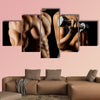 Bodybuilding Strong man and a woman posing on a black background Multi panel canvas wall art