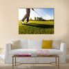 Golfer performs a golf shot from the fairway Multi Panel Canvas Wall Art