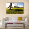 Golfer performs a golf shot from the fairway Multi Panel Canvas Wall Art