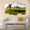 Golfer performs a golf shot from the fairway Multi Panel Canvas Wall Art