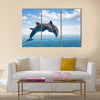 Two jumping dolphins, seascape with deep ocean waters and cloudscape Multi Panel Canvas Wall Art