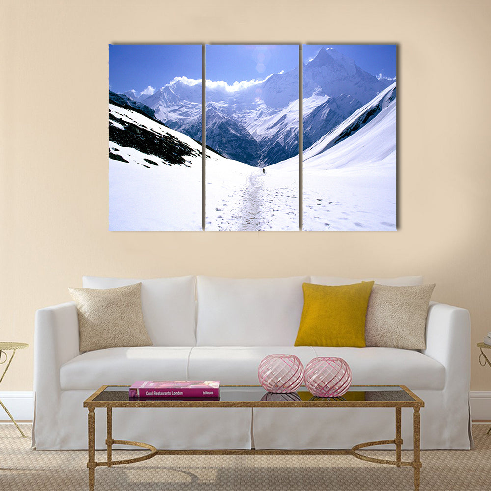 On the way to Annapurna Base Camp in Nepal, a man treks alone Multi panel canvas wall art