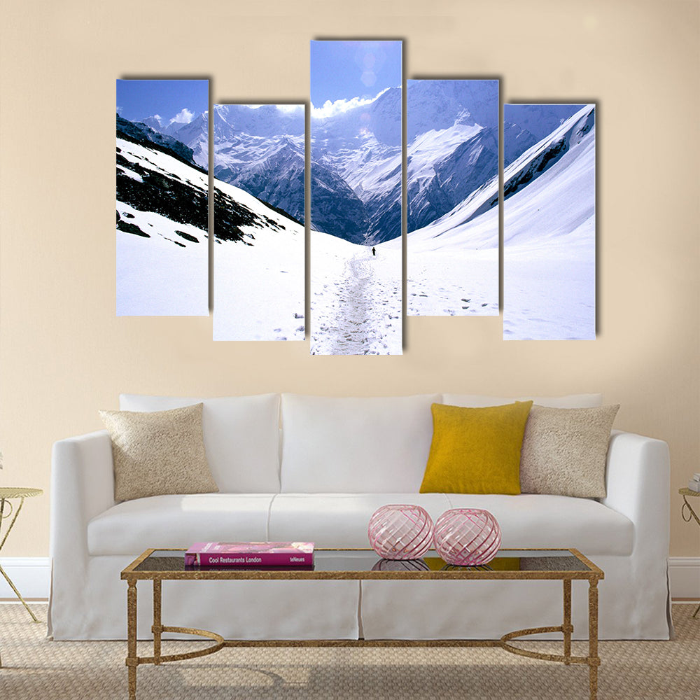 On the way to Annapurna Base Camp in Nepal, a man treks alone Multi panel canvas wall art