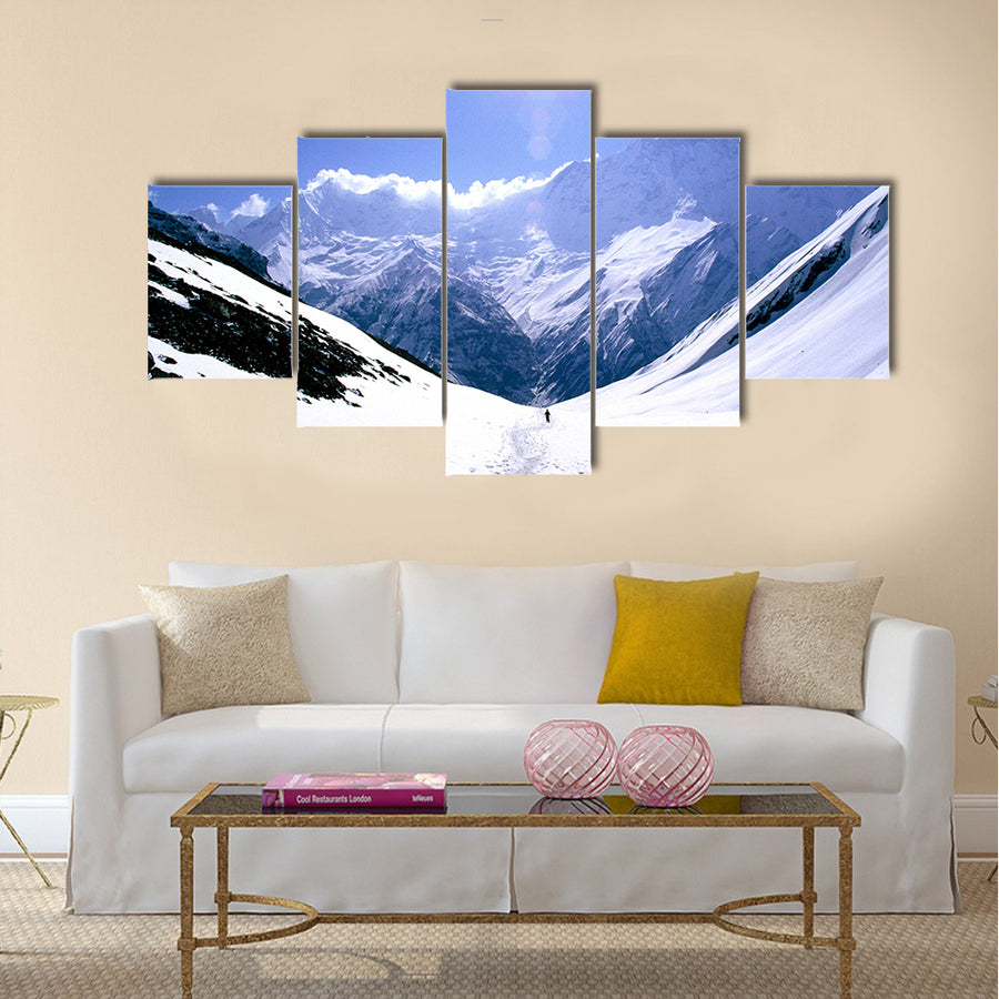 On the way to Annapurna Base Camp in Nepal, a man treks alone Multi panel canvas wall art