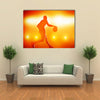 Basketball player silhouette dribbling with lights Multi panel canvas wall art