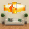 Basketball player silhouette dribbling with lights Multi panel canvas wall art