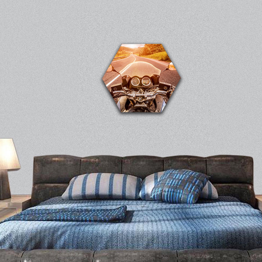 Biker driving a motorcycle rides along the asphalt road hexagonal canvas wall art