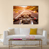 Biker driving a motorcycle rides along the asphalt road. First-person view Multi panel canvas wall art