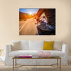 Biker driving a motorcycle rides along the asphalt road Multi panel canvas wall art