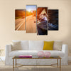 Biker driving a motorcycle rides along the asphalt road Multi panel canvas wall art