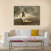 A picture of a biker making a stunt and jumps in the air Multi panel canvas wall art