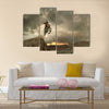 A picture of a biker making a stunt and jumps in the air Multi panel canvas wall art