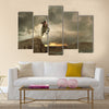 A picture of a biker making a stunt and jumps in the air Multi panel canvas wall art