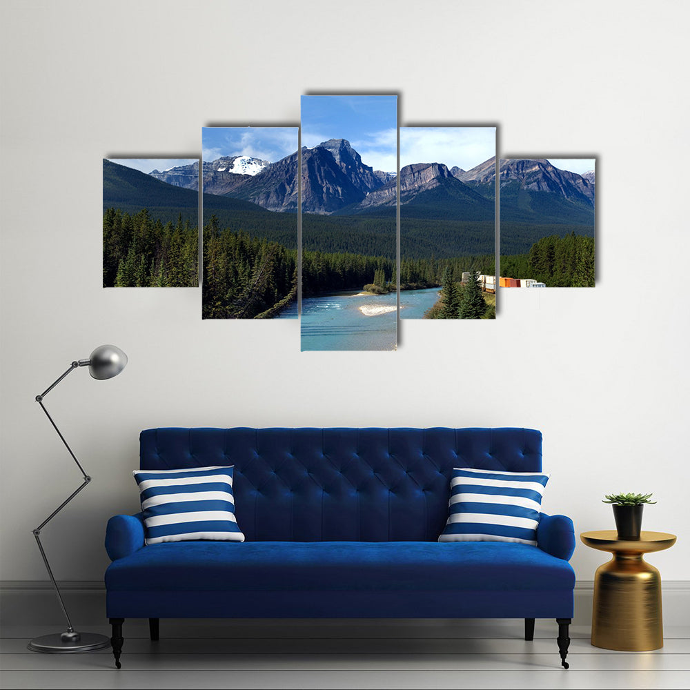 Freight train moving along Bow river in Canadian Rockies Multi panel canvas wall art