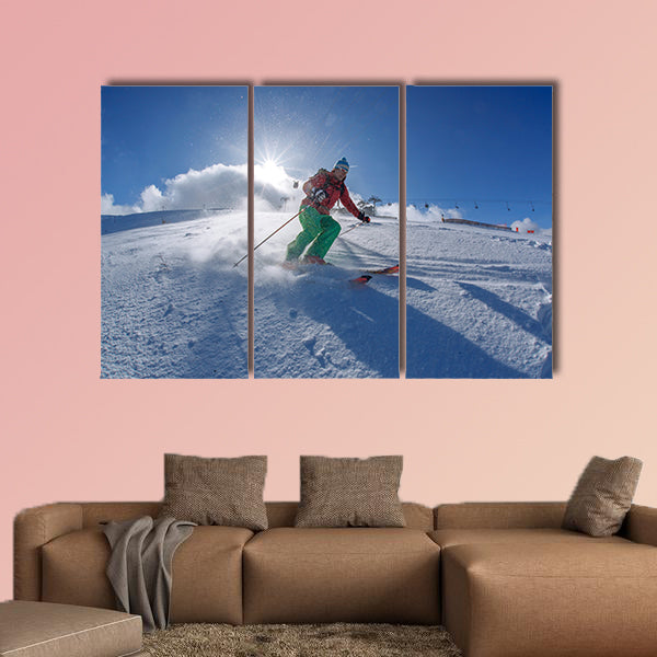 Skier skiing downhill in high mountains against sunset Multi panel canvas wall art