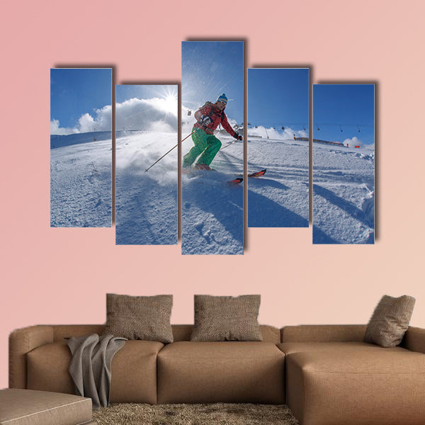 Skier skiing downhill in high mountains against sunset Multi panel canvas wall art