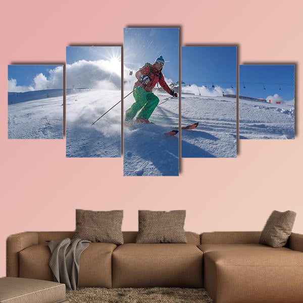 Skier skiing downhill in high mountains against sunset Multi panel canvas wall art