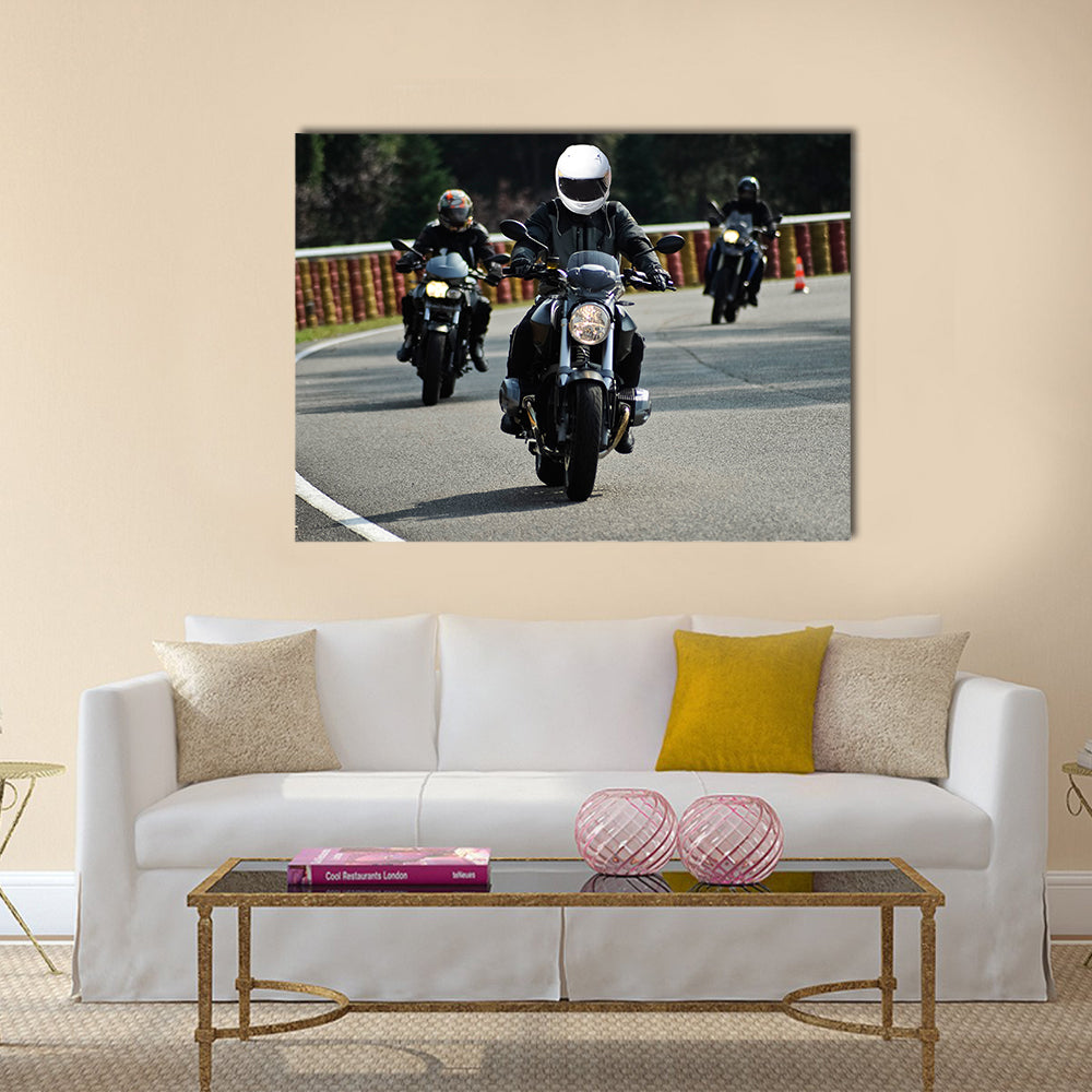 Biker on road with helmet and wet asphalt Multi panel canvas wall art