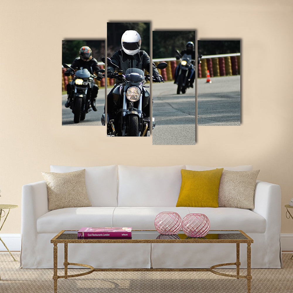 Biker on road with helmet and wet asphalt Multi panel canvas wall art