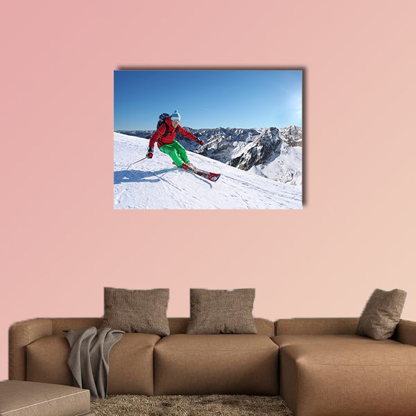 Skier skiing downhill in high mountains against sunset Multi panel canvas wall art