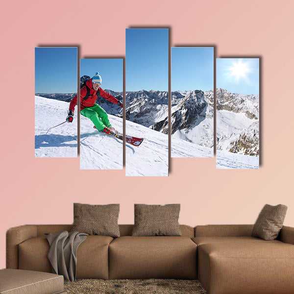 Skier skiing downhill in high mountains against sunset Multi panel canvas wall art