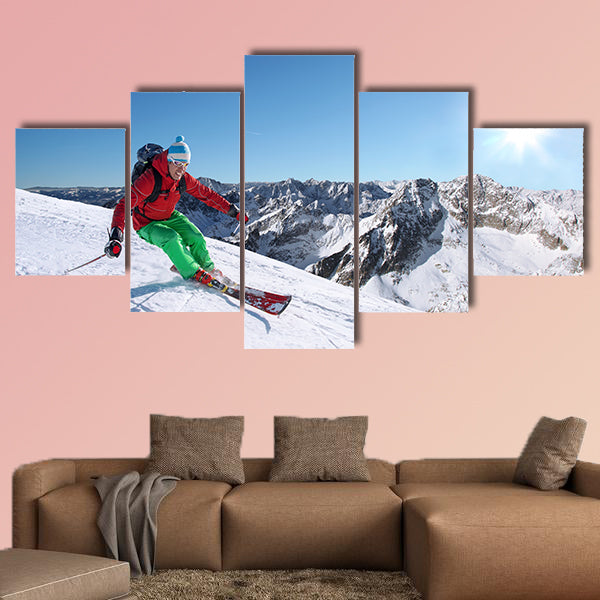 Skier skiing downhill in high mountains against sunset Multi panel canvas wall art