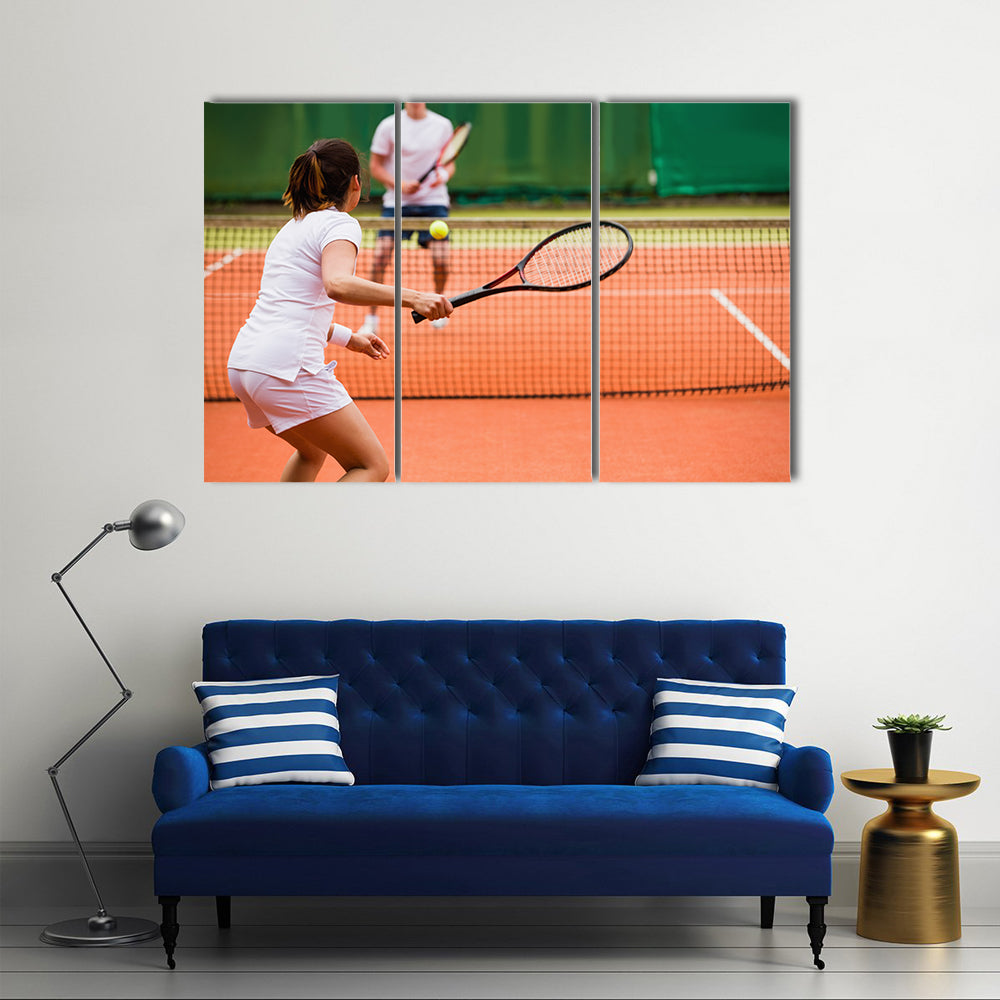 Tennis players playing a match on the court on a sunny day Multi panel canvas wall art