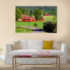 Beautiful old red farm houses in a rural landscape, Sweden canvas wall art