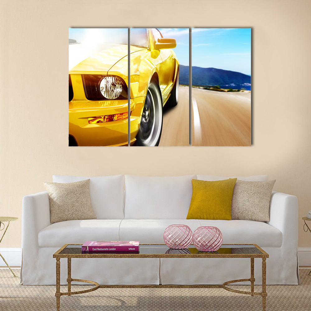 Yellow sport car on a narrow road Multi panel canvas wall art