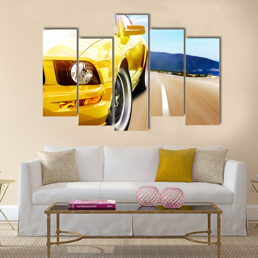 Yellow sport car on a narrow road Multi panel canvas wall art