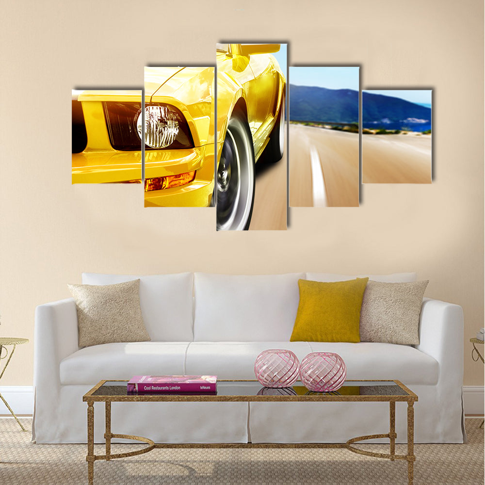 Yellow sport car on a narrow road Multi panel canvas wall art